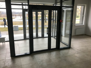 The glass entrance at the entrance to the building store office with sliding double doors
