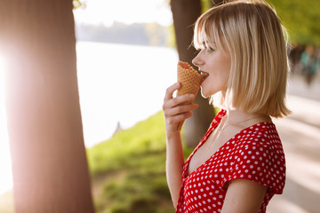 girl with short hair. beautiful young cheerful happy girl eating ice cream smiling in sunny day