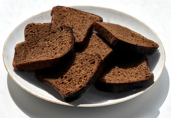 brown bread lies on a plate in the kitchen
