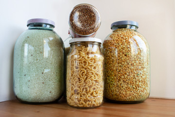 various cereals in glass jars isolated on white background