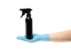 Female hand in protective rubber medical gloves of blue color, hold a bottle of antiseptic. on white background isolate.