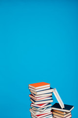a lot of stacks of educational books in the college library on a blue background