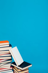 a lot of stacks of educational books in the college library on a blue background