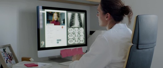 FIXED Caucasian female doctor delivering telemedicine consultation to a patient. Telehealth, telemedicine, remote consultation service. Coronavirus, COVID-19 - Powered by Adobe