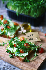 Selective focus. cbd oil note. Toasts with microgreens and cannabis oil. cbd food concept.
