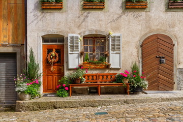 Fototapeta na wymiar Close up on houses in Gruyere village in Fribourg canton by beautiful day, Switzerland