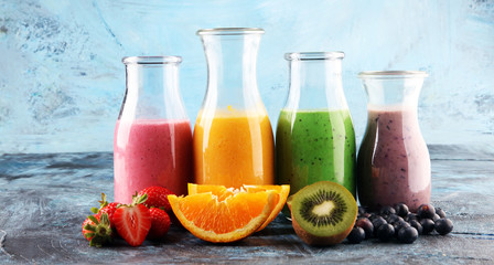 Assortment of fruit smoothies in glass bottles. Fresh organic Smoothie ingredients. Smoothies for health or detox diet food