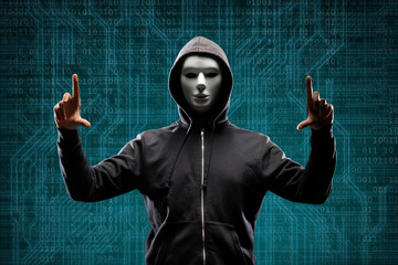 Dangerous hacker over abstract digital background with binary code. Obscured dark face in mask and...