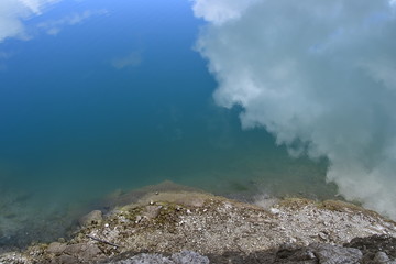 Sky with clouds reflected in the water.