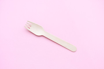 eco friendly disposable kitchenware utensils on pink background. wooden forks and spoons. ecology, zero waste concept. top view. flat lay. minimal style.