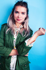 young pretty girl posing happy smiling on blue background, lifestyle people on summer vacation concept