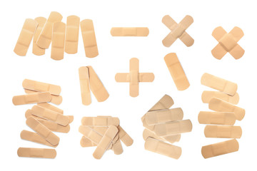 Set with sticking plasters on white background, top view