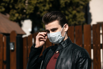 Healthy Man using medical protective mask to health protection and prevention from flu virus, epidemic and infectious diseases