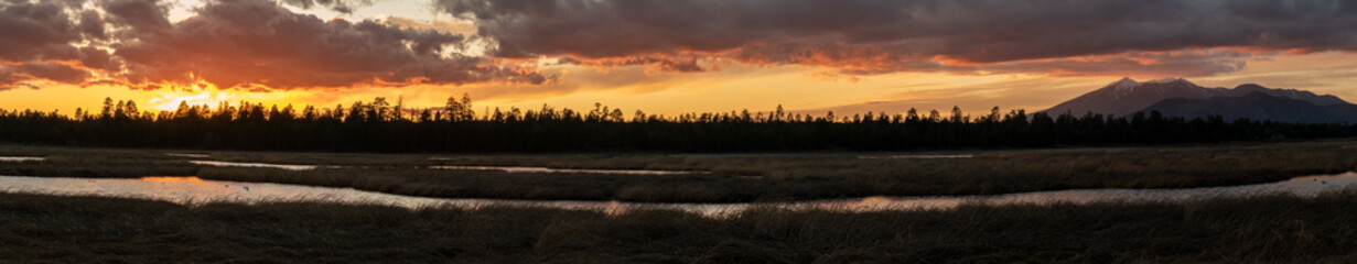 Orange sunset over a mountain lake