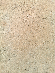 wall with yellow buffy plaster with a crack in the upper part