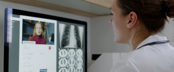 FIXED Caucasian female doctor delivering telemedicine consultation to a patient. Telehealth, telemedicine, remote consultation service. Coronavirus, COVID-19 - Powered by Adobe