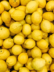 lots of ripe fruit yellow lemons for eating a background