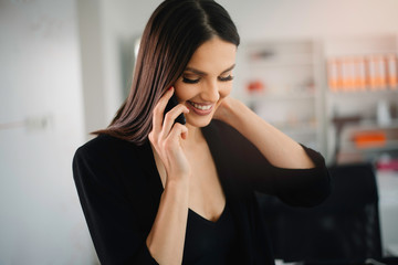 Beautiful businesswoman working in office. Young woman preparing for the meeting.