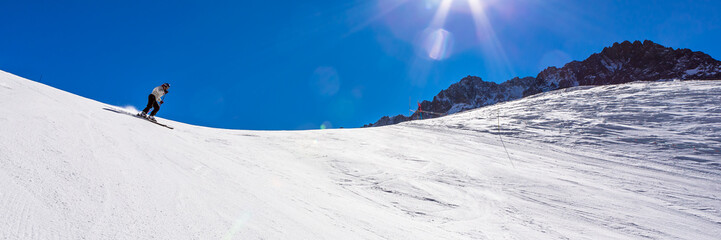 ski in chile on a sunny day with lots of snow.