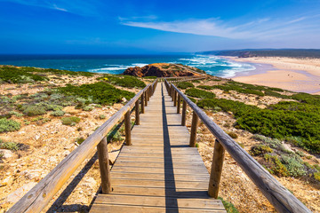 Praia da Bordeira and boardwalks forming part of the trail of tides or Pontal da Carrapateira walk in Portugal. Amazing view of the Praia da Bordeira in portuguese. Bordeira, Algarve, Portugal.