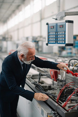 Portrait of handsome businessman. Man working in factory.	