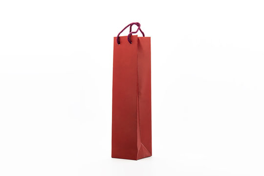 Red paper bag for wine bottles isolated on white background.Can be used for your design and branding.High resolution photo.