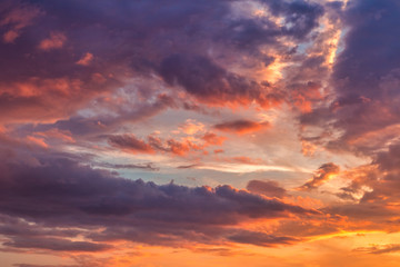 Sky covered with colorful clouds at sunset.