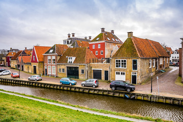 Harlingen, Netherlands - January 10, 2020. Zoutsloot steet with water canal with traditional dutch houses
