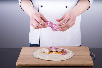 Chef cooking shawarma in restaurant kitchen