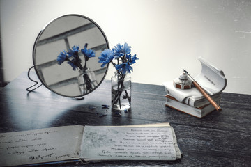 Drawing pad, mirror, inkwell, bouquet of flowers, still life