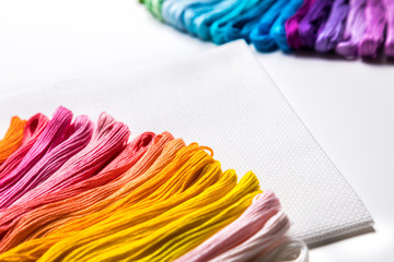 background of multicolored embroidery threads