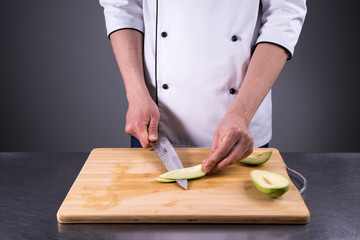 chef cuts and cleans a ripe avocado in the restaurant kitchen6