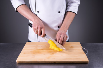 chef slices and peels ripe mango in the restaurant kitchen6
