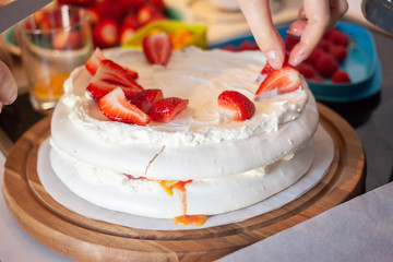 preparing pavlova cake at home female hands