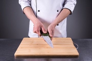 chef cuts cucumber in the restaurant kitchen8