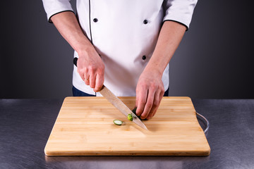 chef cuts cucumber in the restaurant kitchen1