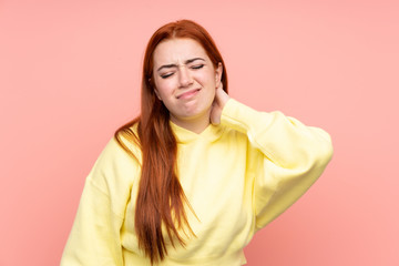 Redhead teenager girl over isolated pink background with neckache