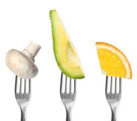 Forks with different vegetables and fruits on white background. Healthy meal