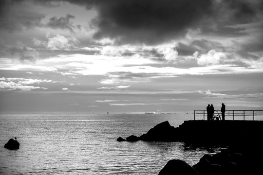 Landscape with storm clouds on the background of the sea, black and white photo