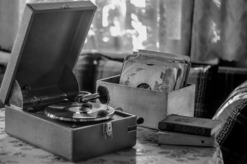 An old gramophone with records is on the table