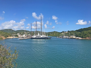 Fototapeta na wymiar View of boats in English Harbour as seen from Fort Berkeley in Antigua and Barbuda, Caribbean, Lesser Antilles, West Indies with blue sky copy space.