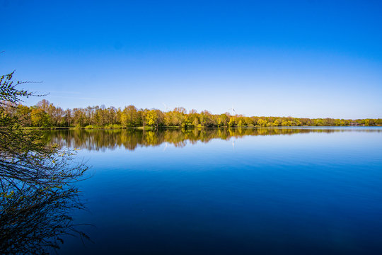 Beautiful, blue and deserted Unisee - a lake in Bremen at sun and blue sky