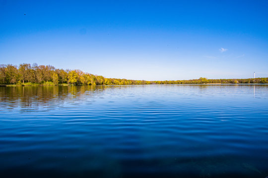 Beautiful, blue and deserted Unisee - a lake in Bremen at sun and blue sky