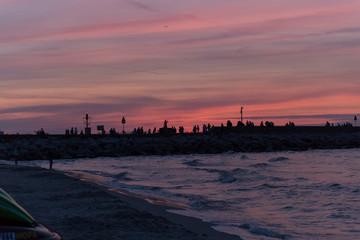 Fototapeta na wymiar sunset over a harbour pier