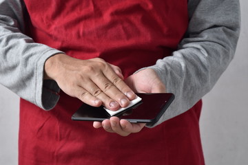 men cleaning smartphone screen with alcohol.