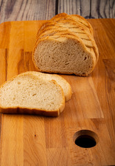 Sliced loaf of wheat bread on a wooden cutting Board. Close up.
