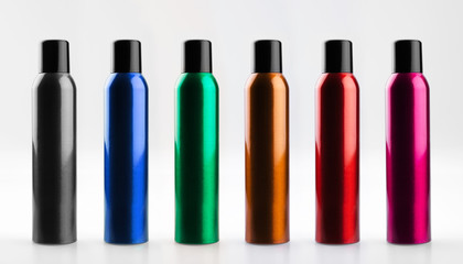 Set of colorful, beauty aerosol cans of aluminum with caps. Cosmetic hairspray bottles. Isolated on white background.