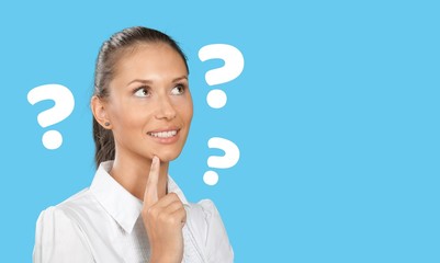 Question sign with a beautiful alarmed woman on pastel background