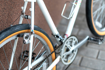 Obraz premium Old mountain bike against the wall. Repair of retro bicycles. Bicycle as a means of preserving health. Fashionable bicycle for teenagers and hipsters.