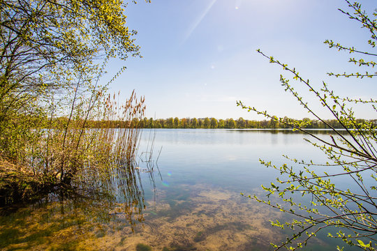 Beautiful, blue and deserted Unisee - a lake in Bremen at sun and blue sky